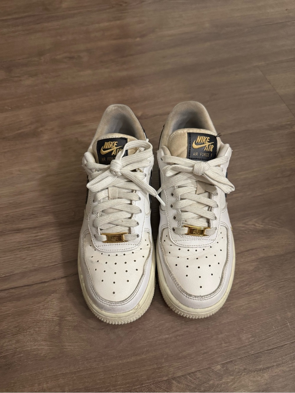 Nike Air Force 1 07’ Essential “White/Black/Gold mini swoosh”